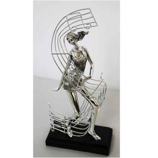 Read more about Female dancer with musical note sculpture