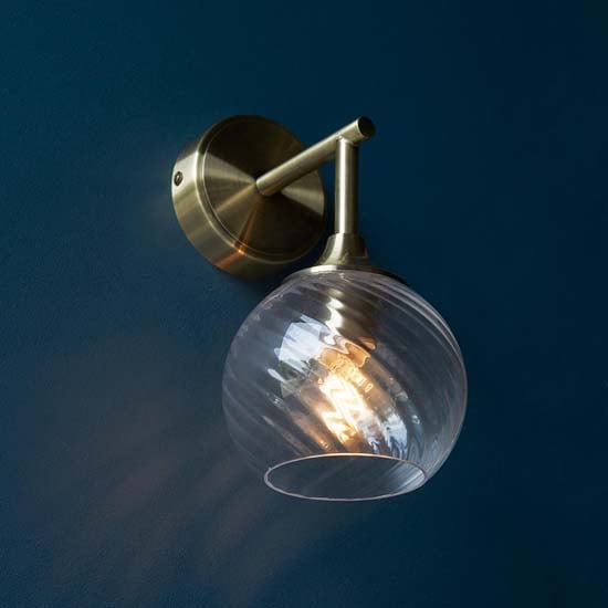 Read more about Accra clear spiral glass shade wall light in antique brass