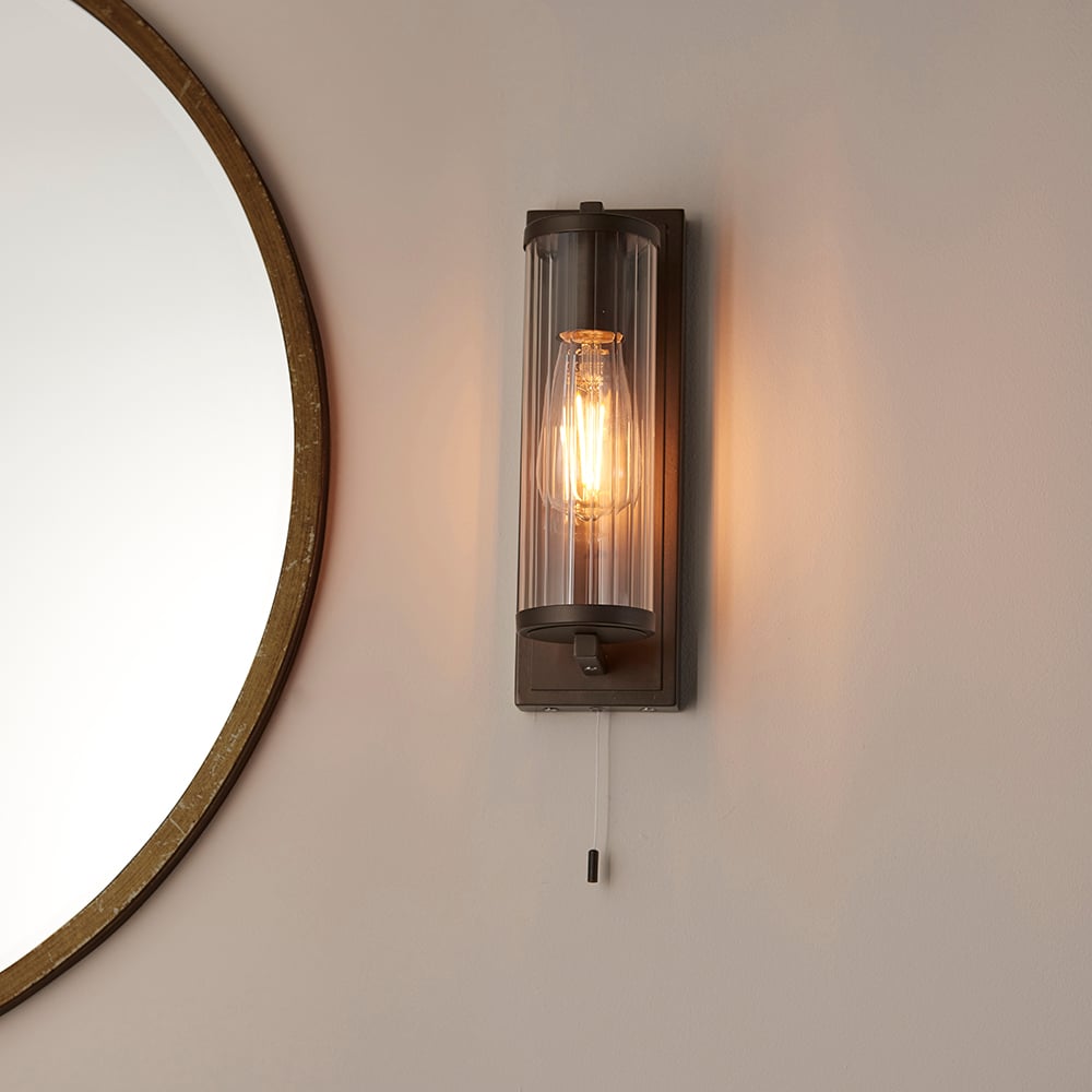 Read more about Adel cylinder clear glass shade bathroom wall light in bronze