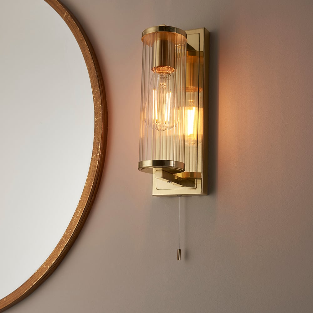 Read more about Adel cylinder clear glass shade bathroom wall light in gold