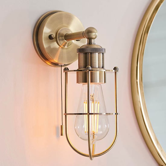 Adrian Industrial Caged Wall Light In Antique Brass