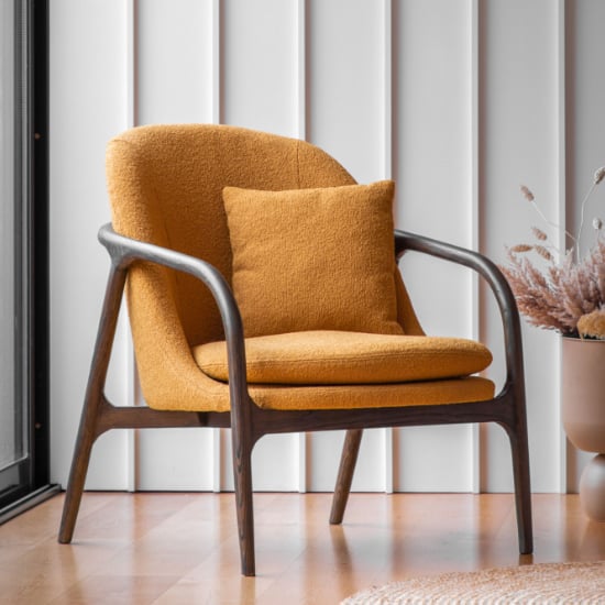 View Allegra fabric armchair with dark wooden frame in ochre
