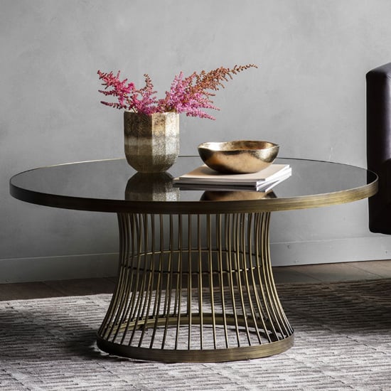 Read more about Alexxis round glass top coffee table in bronze