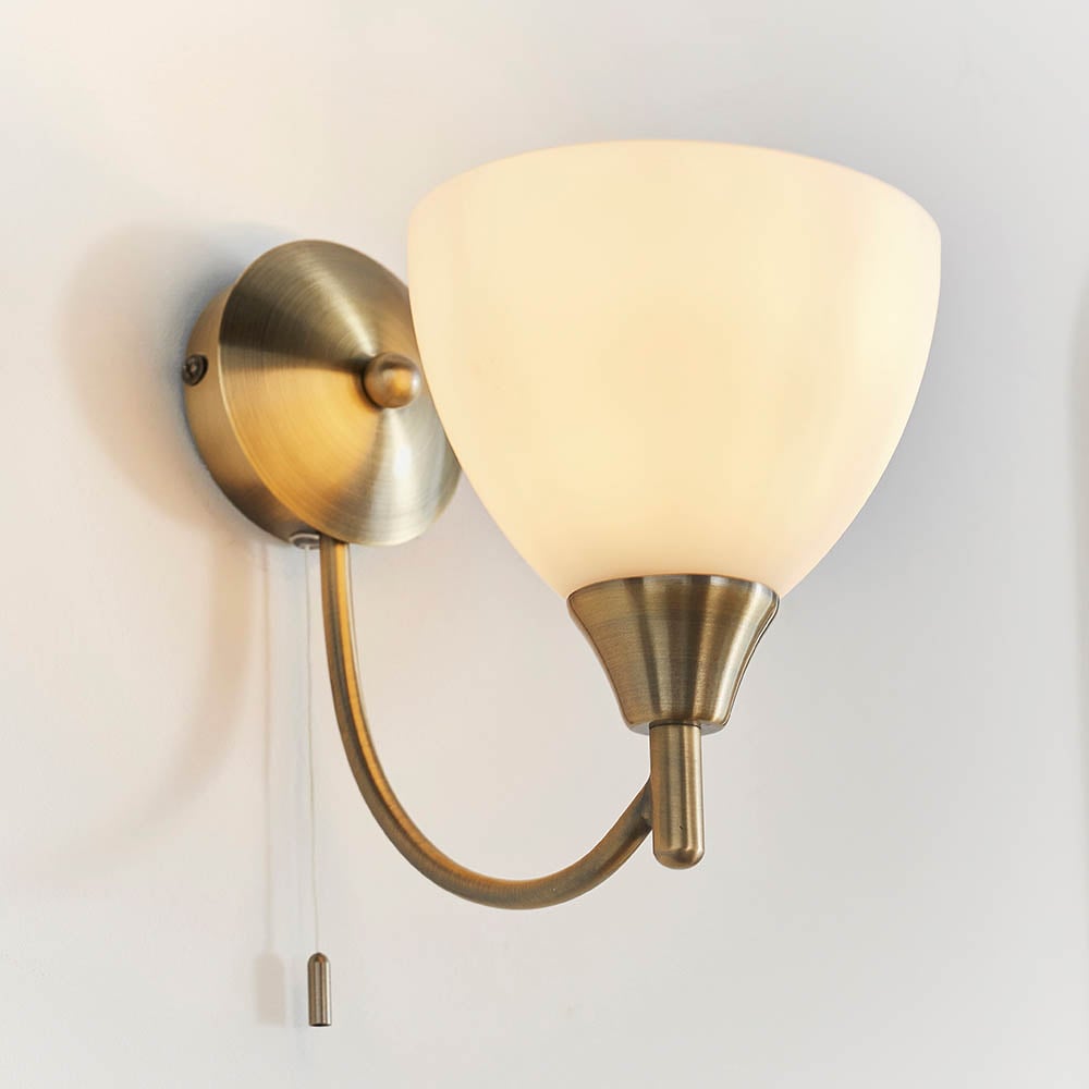 Read more about Alton matt opal glass shade wall light in antique brass