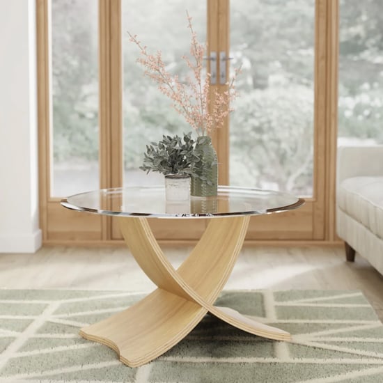 View Anfossi round clear glass coffee table with oak legs