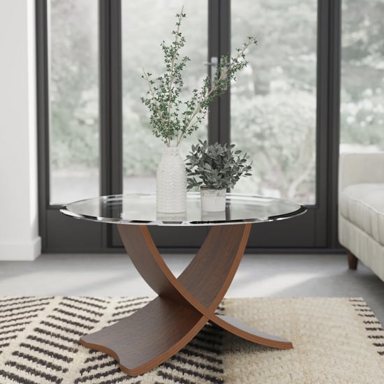 Photo of Anfossi round clear glass coffee table with walnut legs