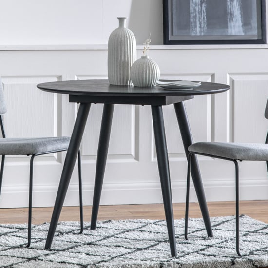 Photo of Aptly round wooden dining table in black oak