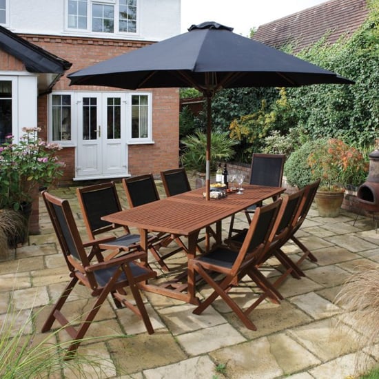 Photo of Boarhunt wooden dining set in factory stain with large parasol