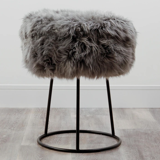 Photo of Bovril sheepskin stool with black metal legs in grey