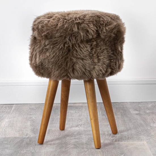 Photo of Bovril sheepskin stool with oak wooden legs in light brown