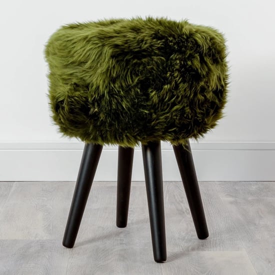 Photo of Bovril sheepskin stool with black wooden legs in olive green