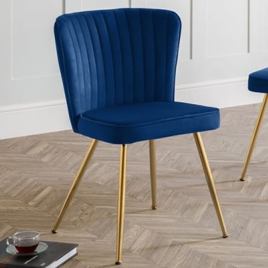 Photo of Caledon velvet dining chair in blue with gold metal legs