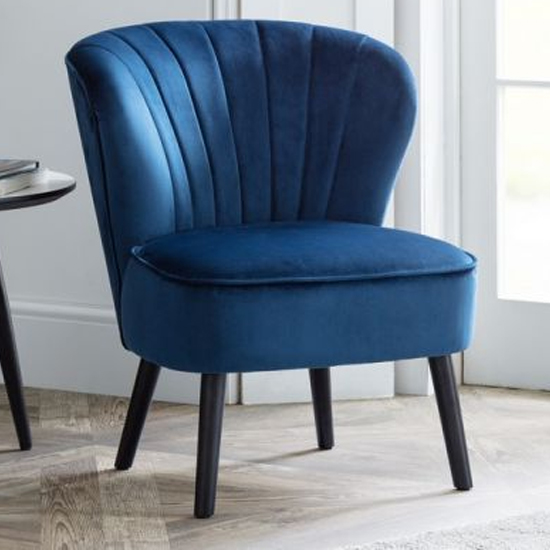 Photo of Caliste velvet bedroom chair in blue with black wooden legs