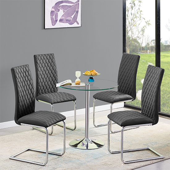 Photo of Dante round clear glass dining table with 4 ronn black chairs