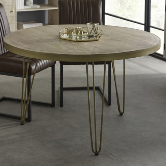 Photo of Dhort round wooden dining table in natural