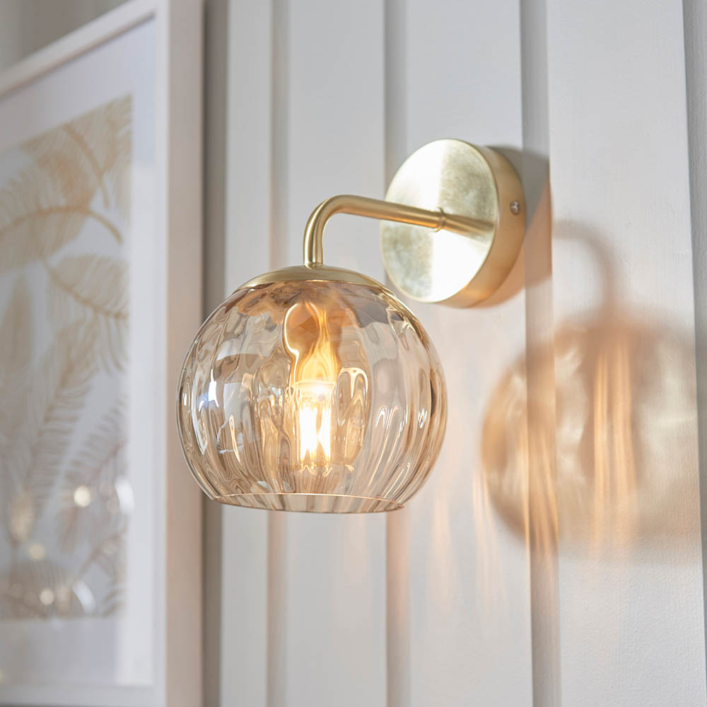 Read more about Dimple champagne glass shade wall light in brass