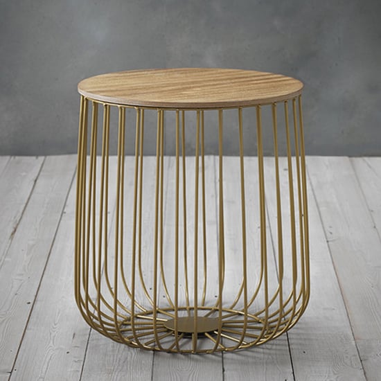 Photo of Enzi small wooden coffee table with gold cage frame in oak