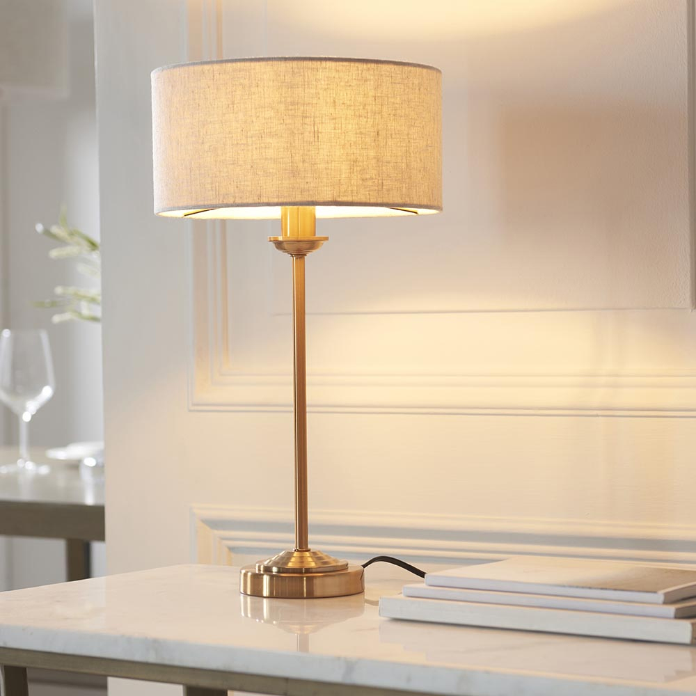 Read more about Hixson natural fabric shade table lamp in aged brass
