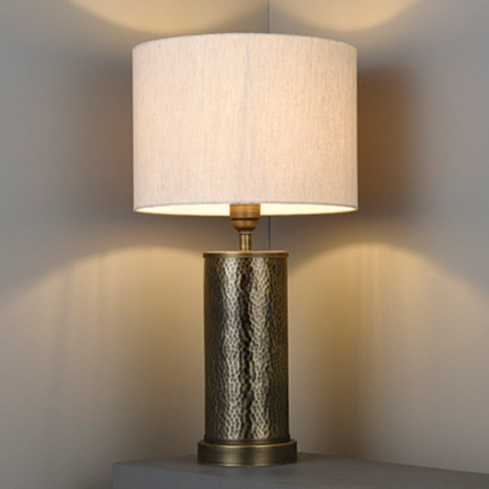 Photo of Indara natural linen shade table lamp in hammered bronze