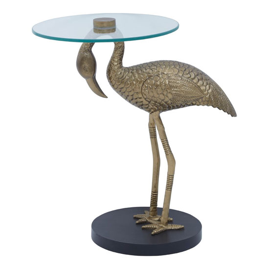 Photo of Inventive round clear glass side table with gold pelican base