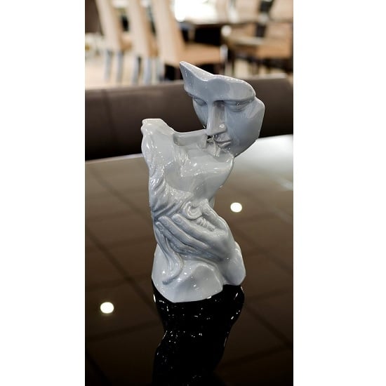 Photo of Lovers kissing sculpture in grey ceramic