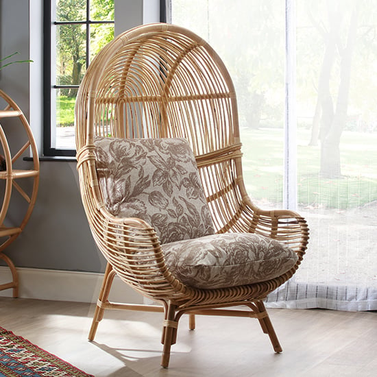 Photo of Loum rattan armchair with foral beige seat cushion