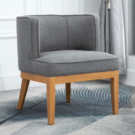 Photo of Lucille fabric upholstered armchair in dark grey