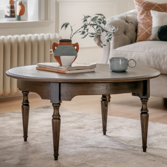 Photo of Madisen round wooden coffee table in coffee