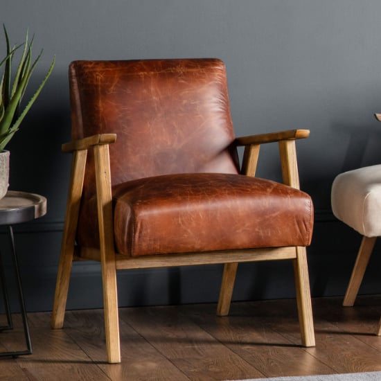 Photo of Neelan leather armchair with wooden frame in vintage brown