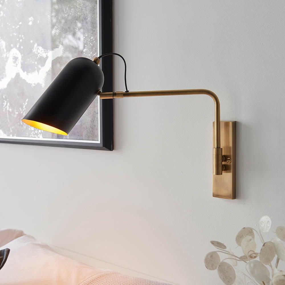 Read more about Newkirk matt black shade metal wall light in antique brass