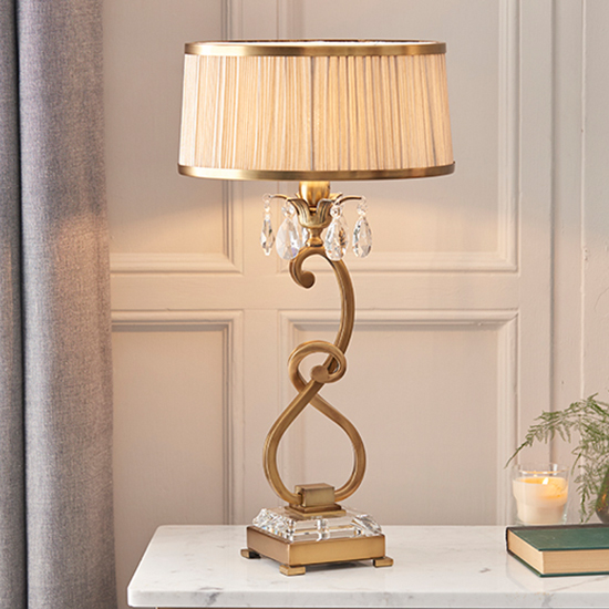 Photo of Oksana medium table lamp in antique brass with beige shade