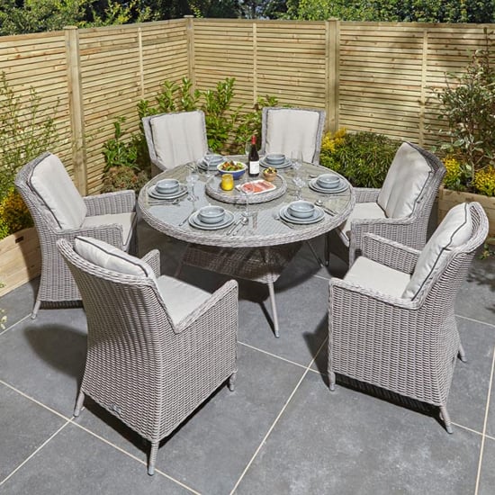 Photo of Peebles round dining table with 6 chairs in natural stone