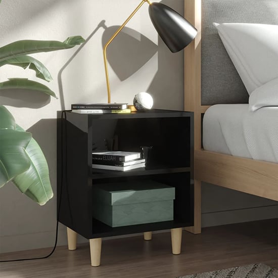 Photo of Pilis high gloss bedside cabinet in black with natural legs