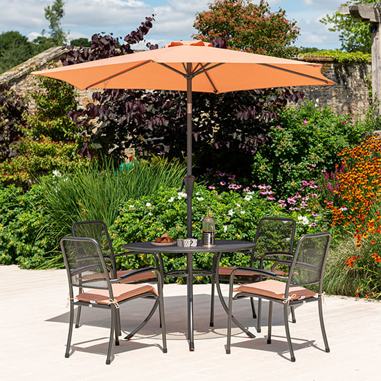 Product photograph of Prats Outdoor Dining Table With 4 Chairs And Parasol In Ochre from Furniture in Fashion