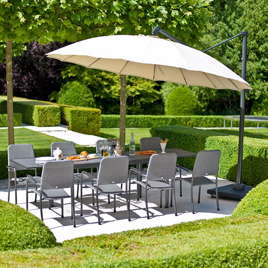 Photo of Prats extending dining table 8 armchairs parasol in charcoal