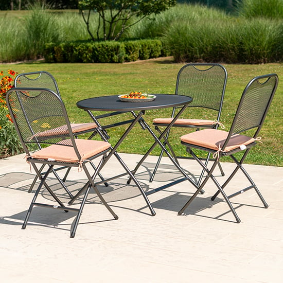Photo of Prats outdoor round dining table with 4 chairs in ochre