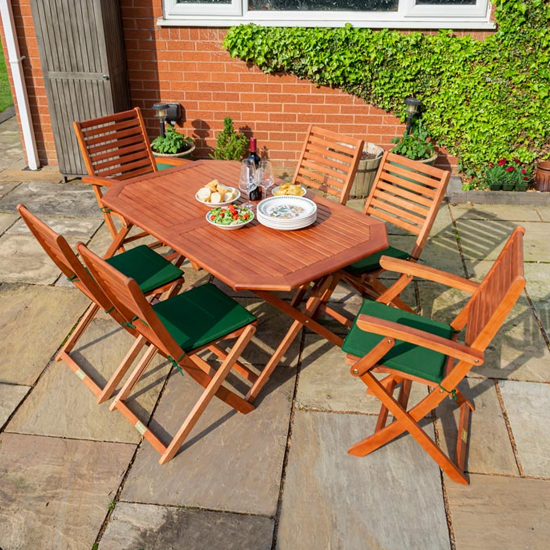 Read more about Putey dining table with 6 green cushion chairs in factory stain