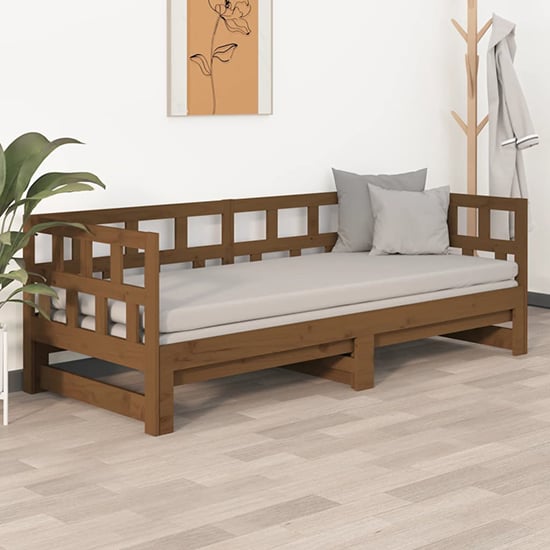 Photo of Rivas solid pinewood pull-out single day bed in honey brown