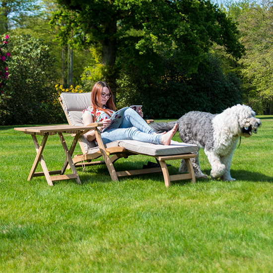 View Robalt wooden steamer relaxing chair with side table in natural