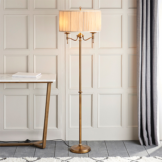 Photo of Stanford floor lamp in antique brass with beige shade