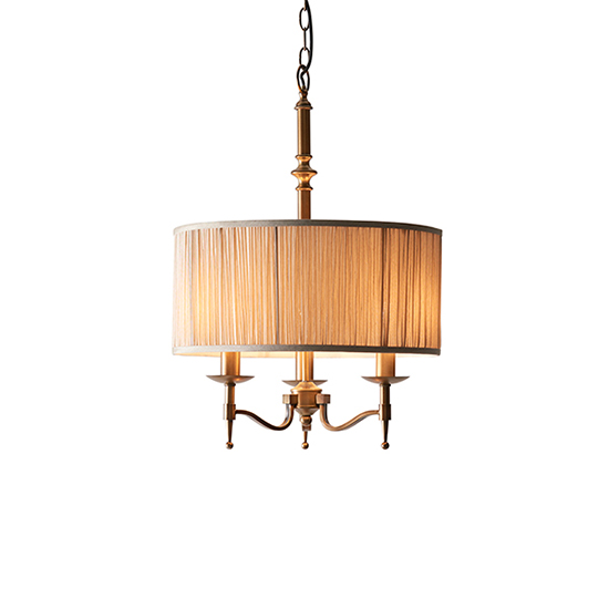 Photo of Stanford round pendant light in antique brass with beige shade