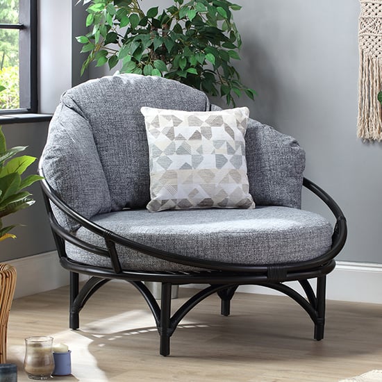 Product photograph of Surgut Rattan Snug Chair In Black With Earth Grey Cushion from Furniture in Fashion