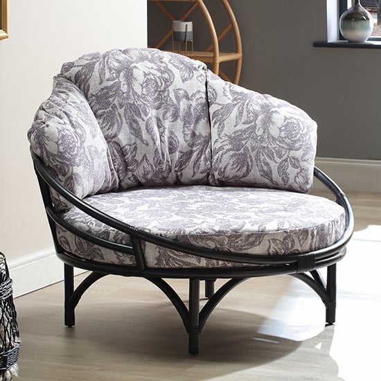 Product photograph of Surgut Rattan Snug Chair In Black With Floral Lilac Cushion from Furniture in Fashion