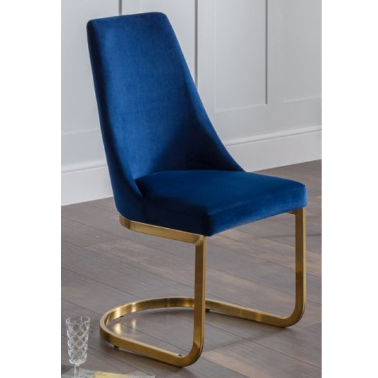 Photo of Vangie velvet cantilever dining chair in blue with gold base