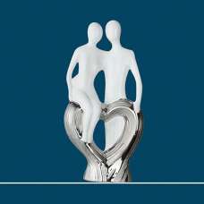 Moline Ceramics Couple Sitting On Heart Sculpture In White - UK